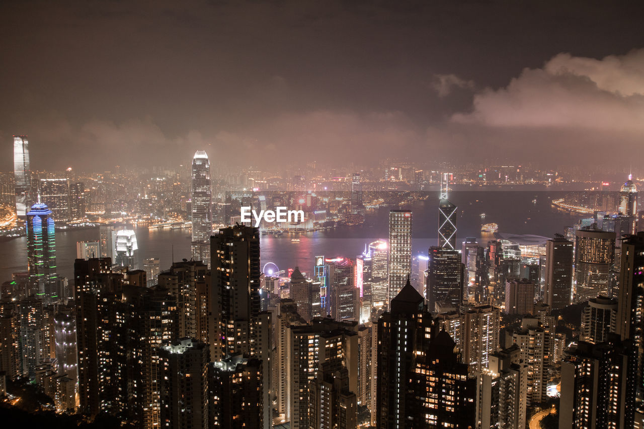 Illuminated cityscape against sky at night