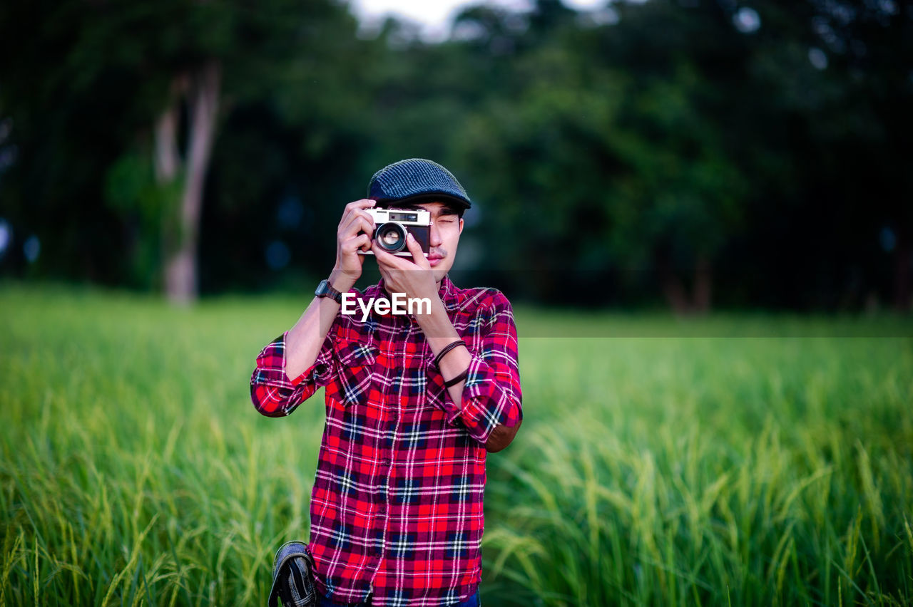 MAN WEARING SUNGLASSES ON FIELD