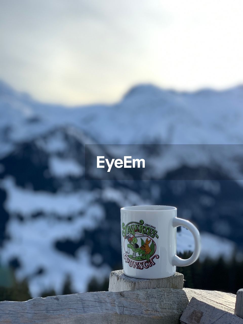 CLOSE-UP OF COFFEE CUP ON TABLE AGAINST SKY