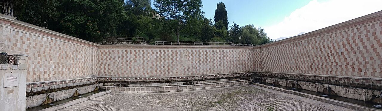 EMPTY ROAD WITH BUILT STRUCTURE IN BACKGROUND