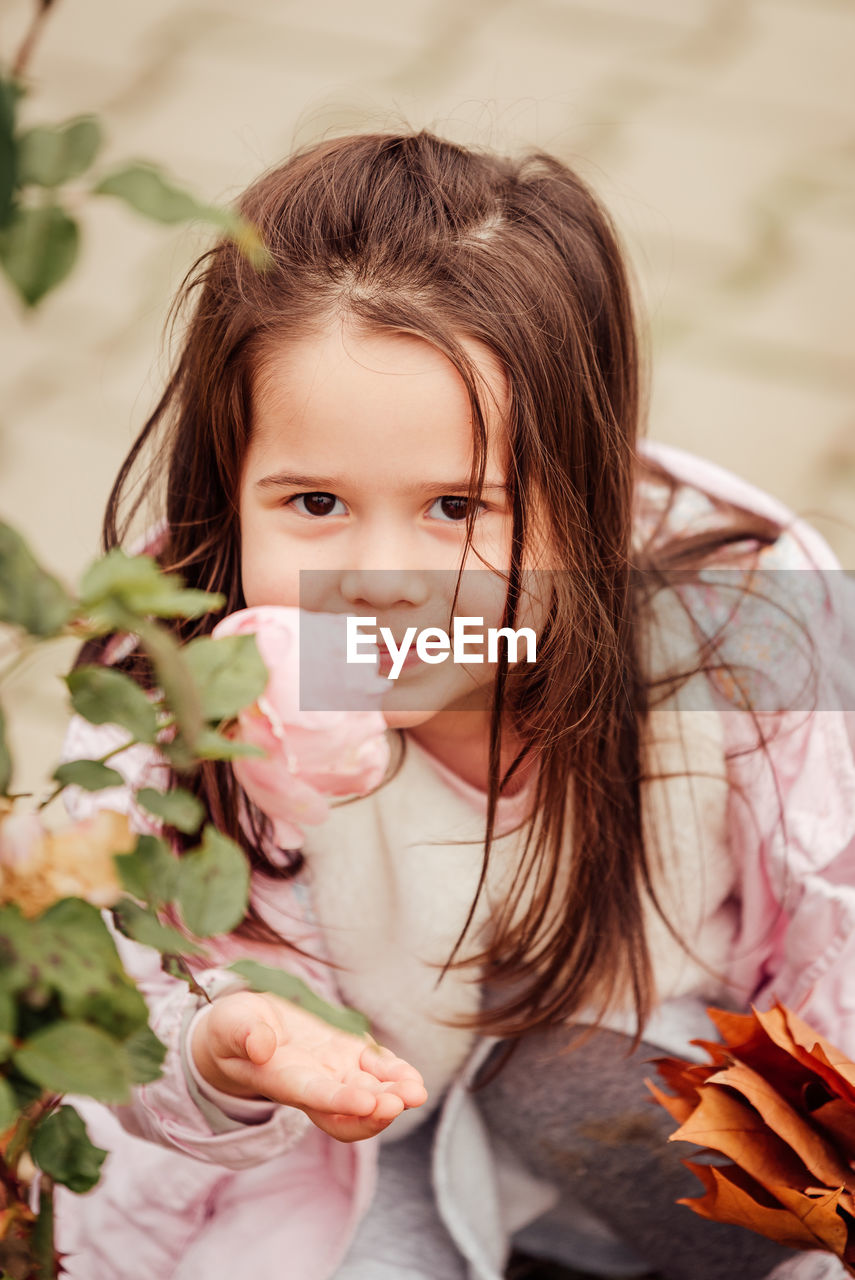 Portrait of cute girl smelling flower