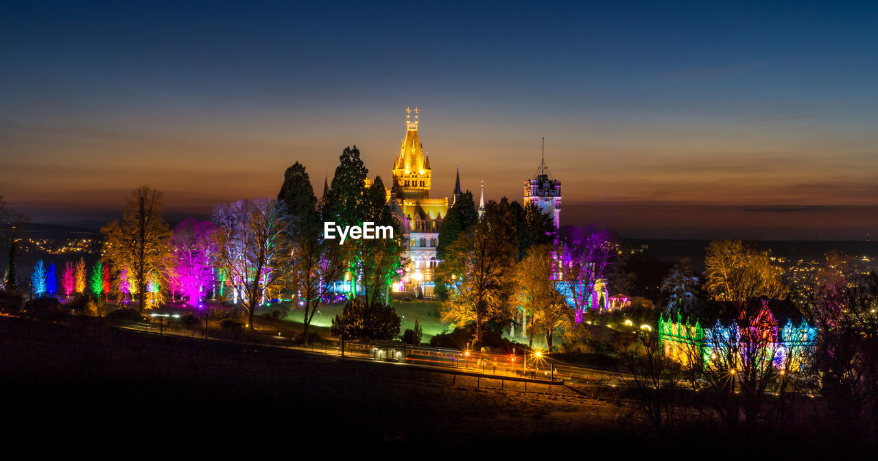 ILLUMINATED CITYSCAPE AT NIGHT