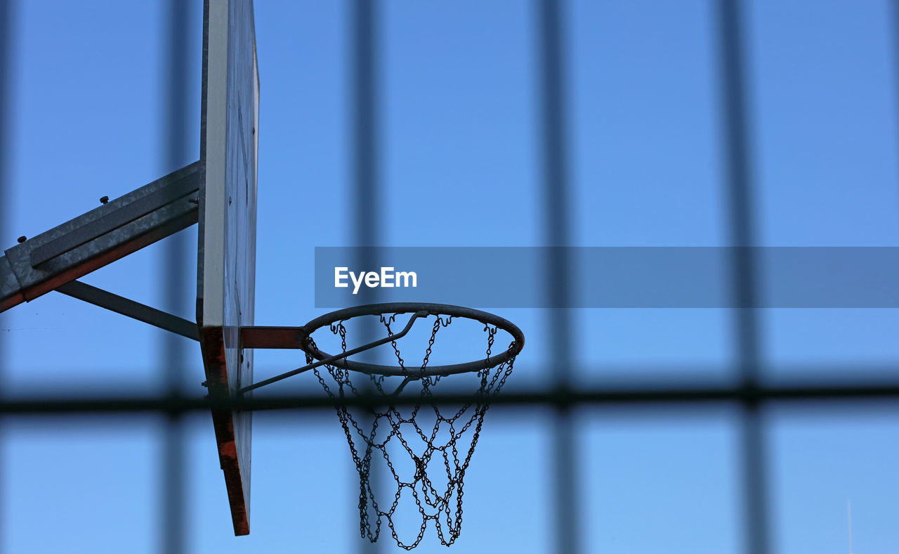 Low angle view of basketball hoop against blue sky