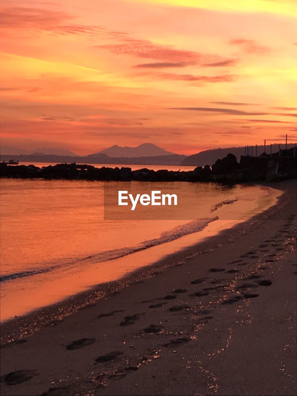 Scenic view of beach against sky during sunset