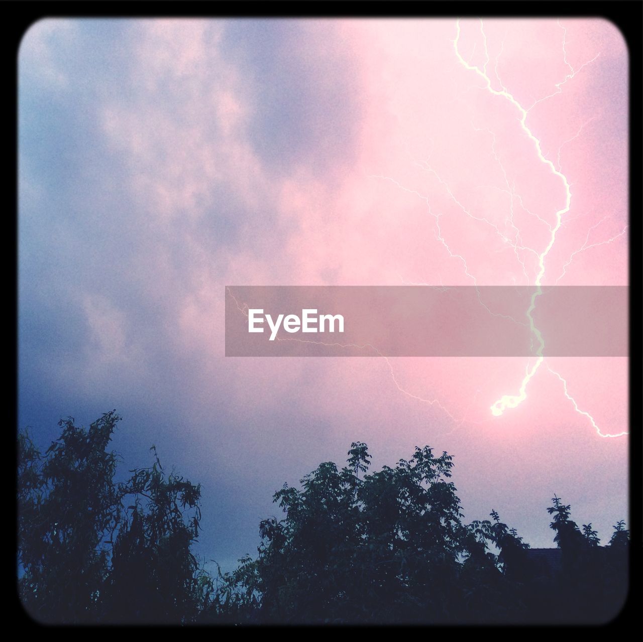 Lightning strike against cloudy sky