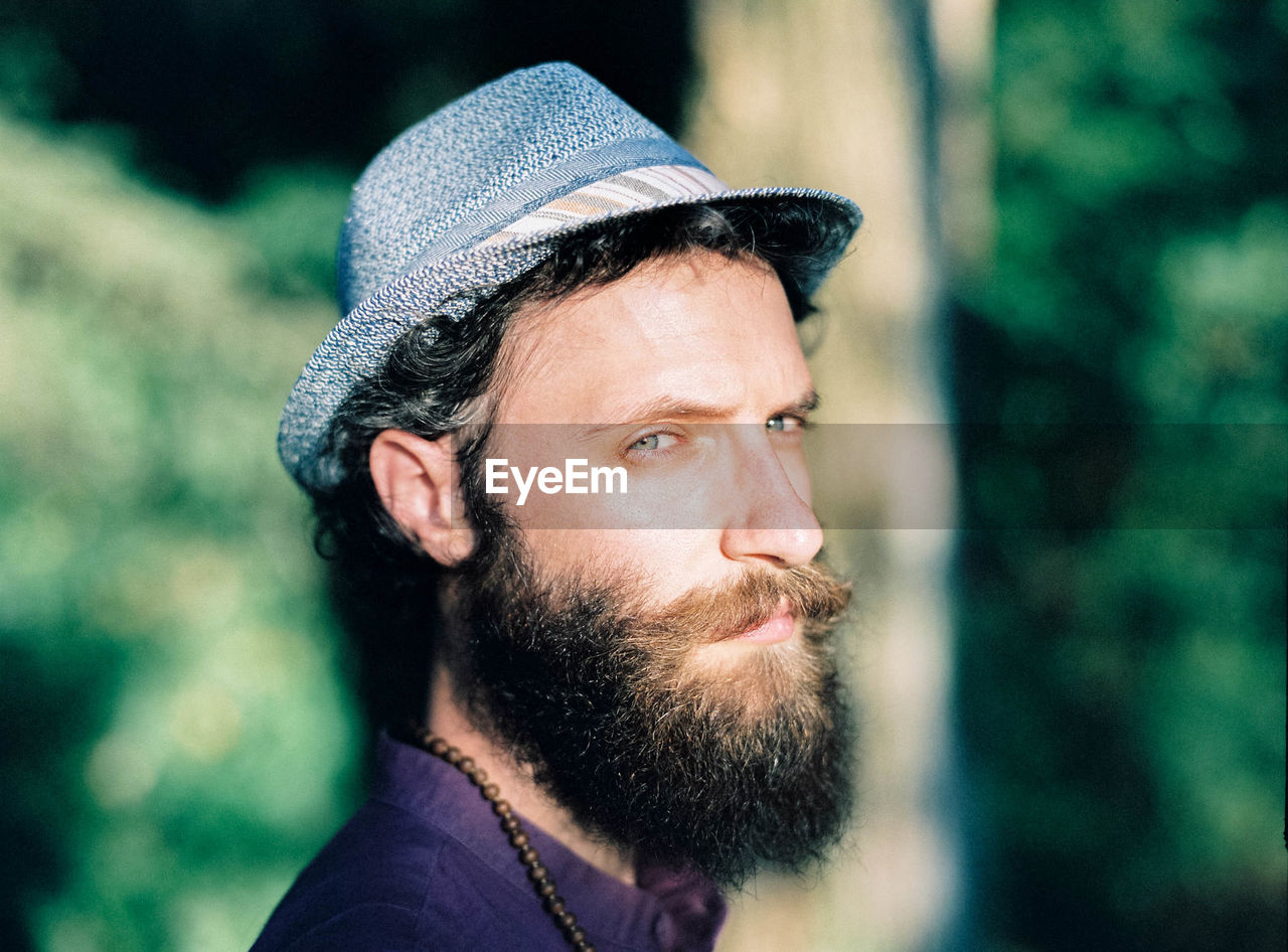 Close-up portrait of bearded man wearing hat