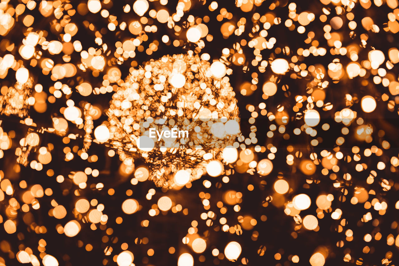 Defocused image of illuminated christmas lights at night