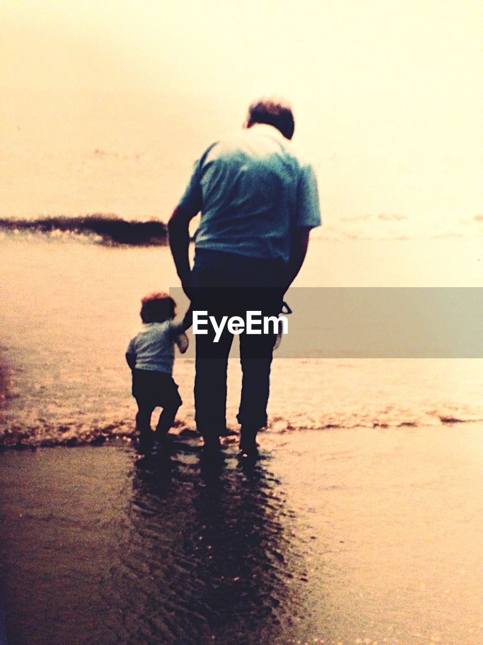 Senior man with grandson at sea