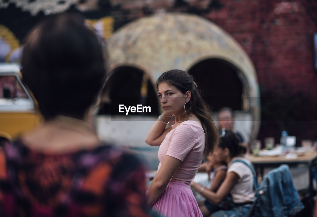 Side view of thoughtful woman standing outdoors