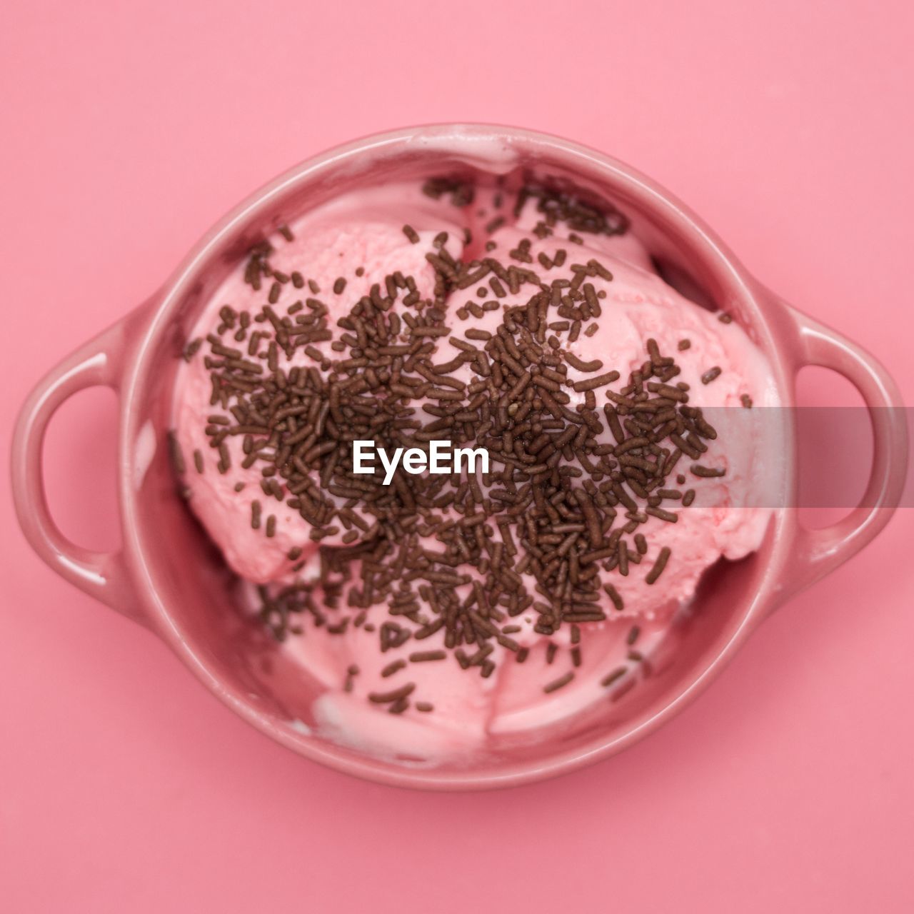 Close-up of ice cream in bowl on pink background