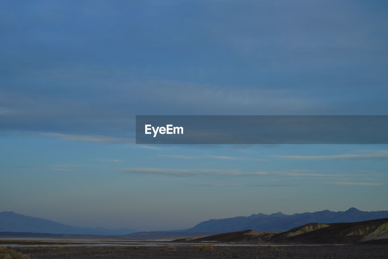 Scenic view of landscape against blue sky