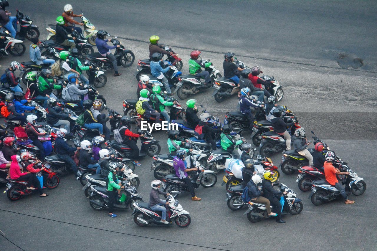 High angle view of people riding motorcycles on road