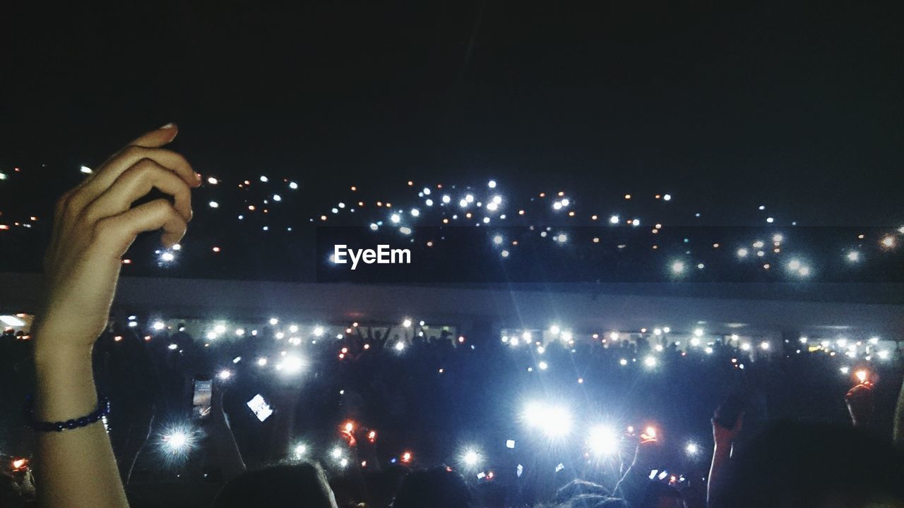 VIEW OF ILLUMINATED CITY AT NIGHT