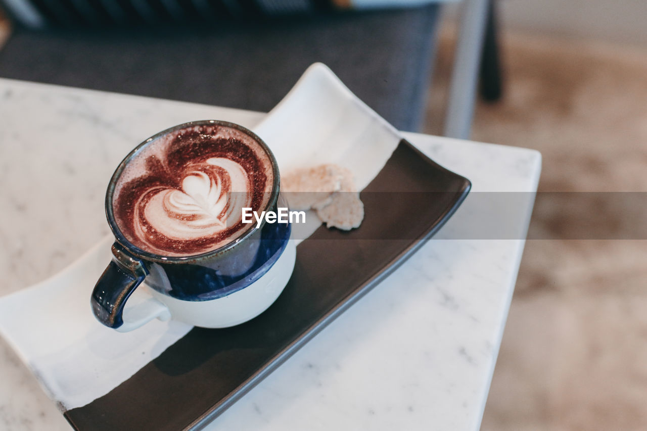 HIGH ANGLE VIEW OF COFFEE CUP WITH CHOCOLATE CAKE