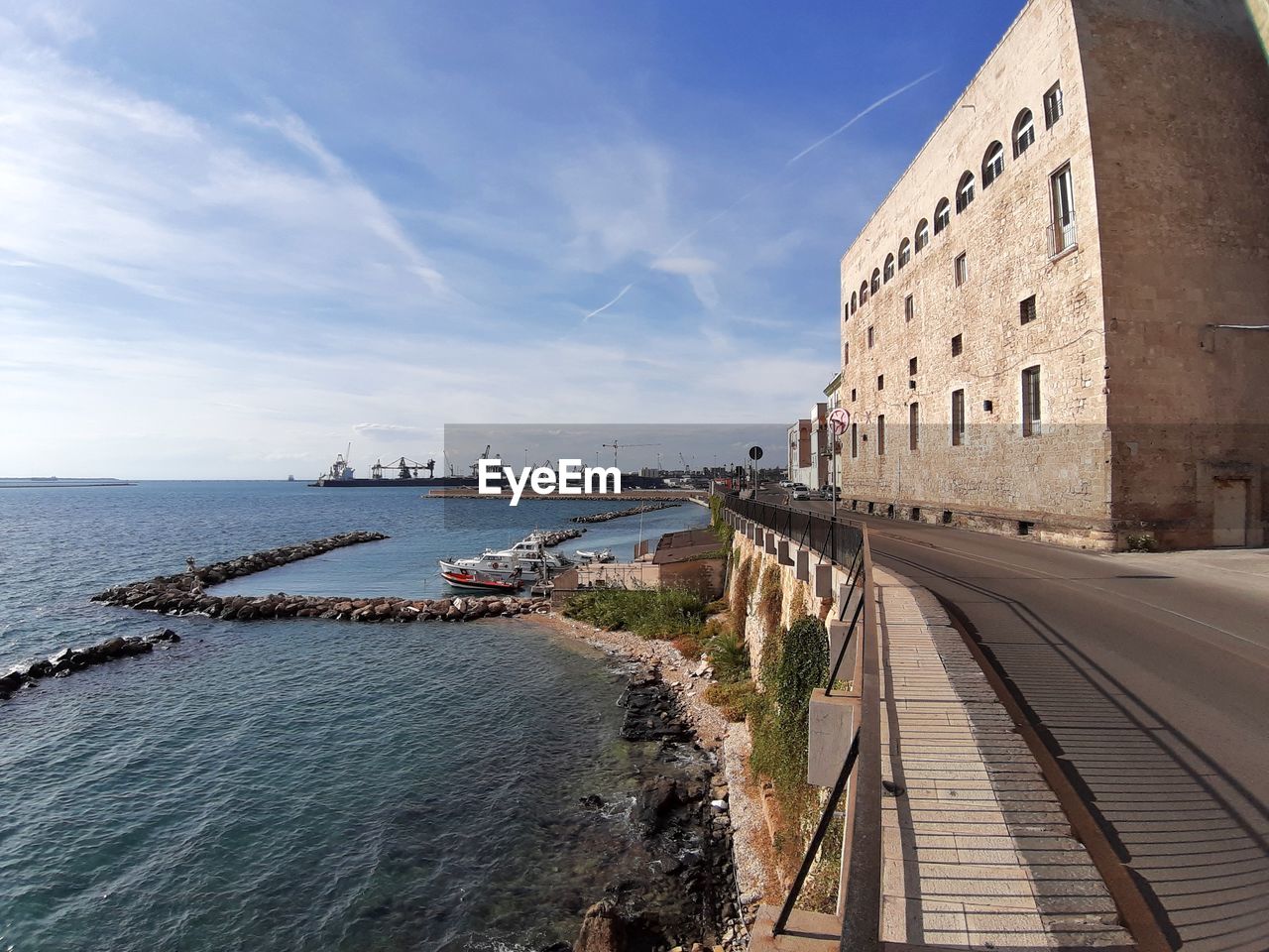 PANORAMIC VIEW OF BEACH BY BUILDINGS AGAINST SKY