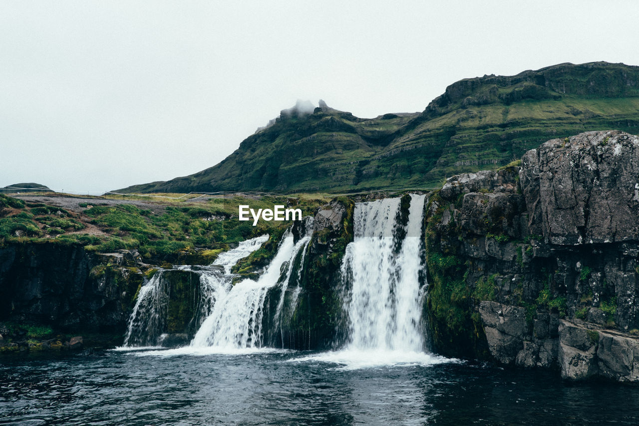 Scenic view of waterfall against clear sky