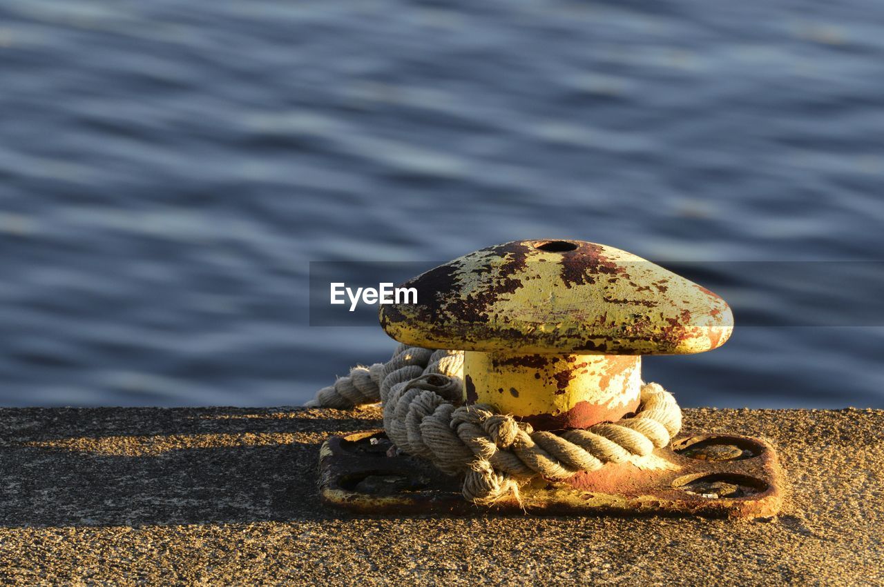 Close-up of rope tied on pier