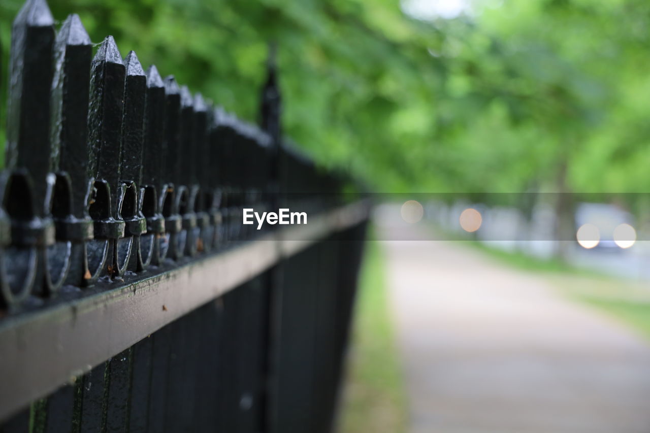 Close-up of railing by fence