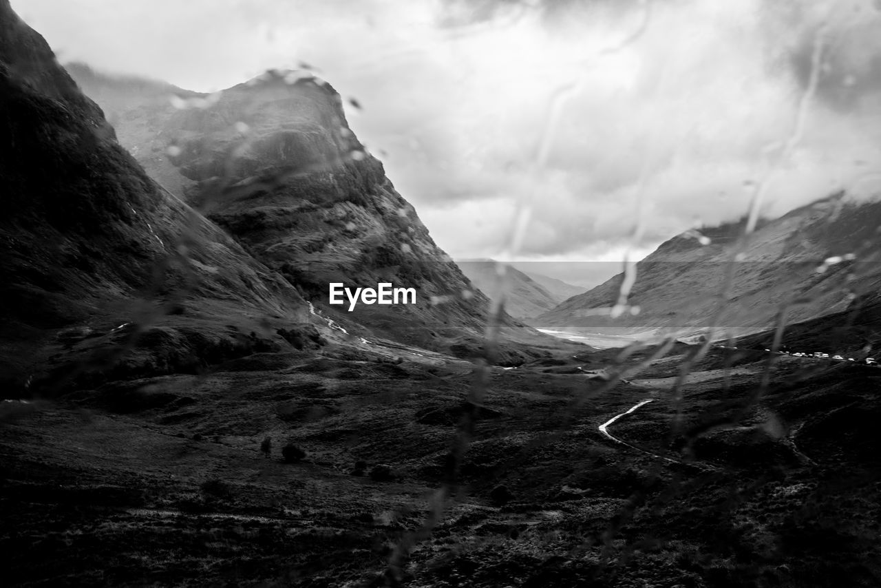 CLOSE-UP OF MOUNTAINS AGAINST SKY