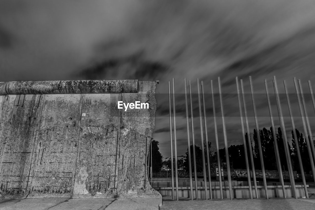 Low angle view of abandoned wall against sky