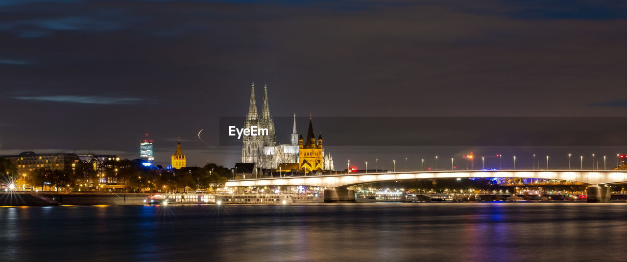 ILLUMINATED CITY BUILDINGS AT NIGHT