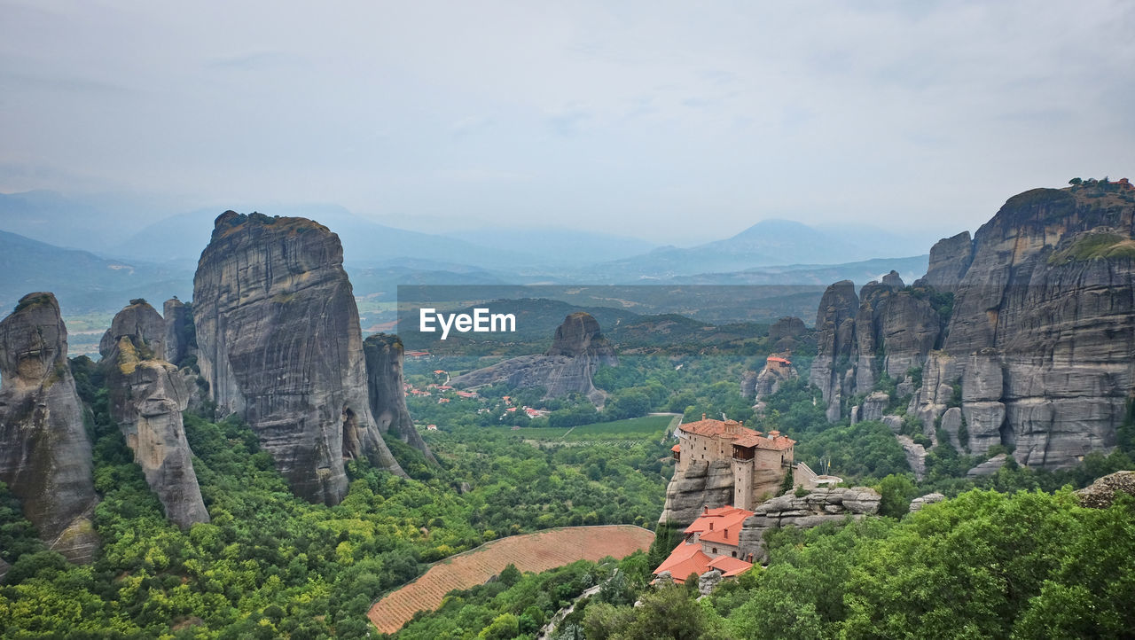 mountain, scenics - nature, environment, landscape, nature, travel destinations, travel, land, sky, beauty in nature, mountain range, rock, plant, tree, terrain, architecture, history, tourism, valley, rock formation, outdoors, tranquility, no people, cliff, the past, cloud, ancient, tranquil scene, non-urban scene, day, built structure, building, religion, landmark, canyon