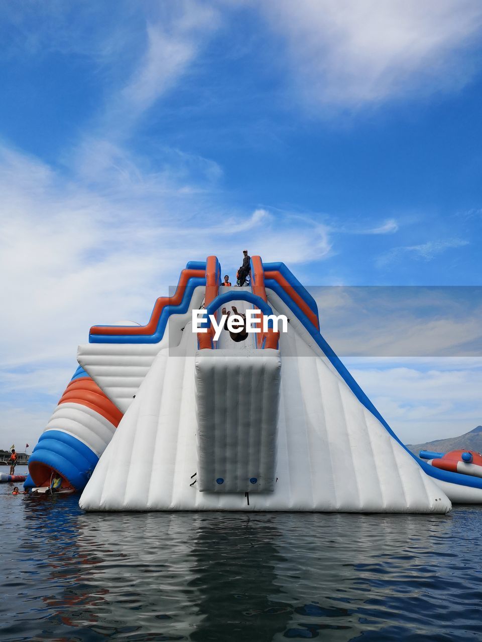 BOAT SAILING IN SEA AGAINST SKY