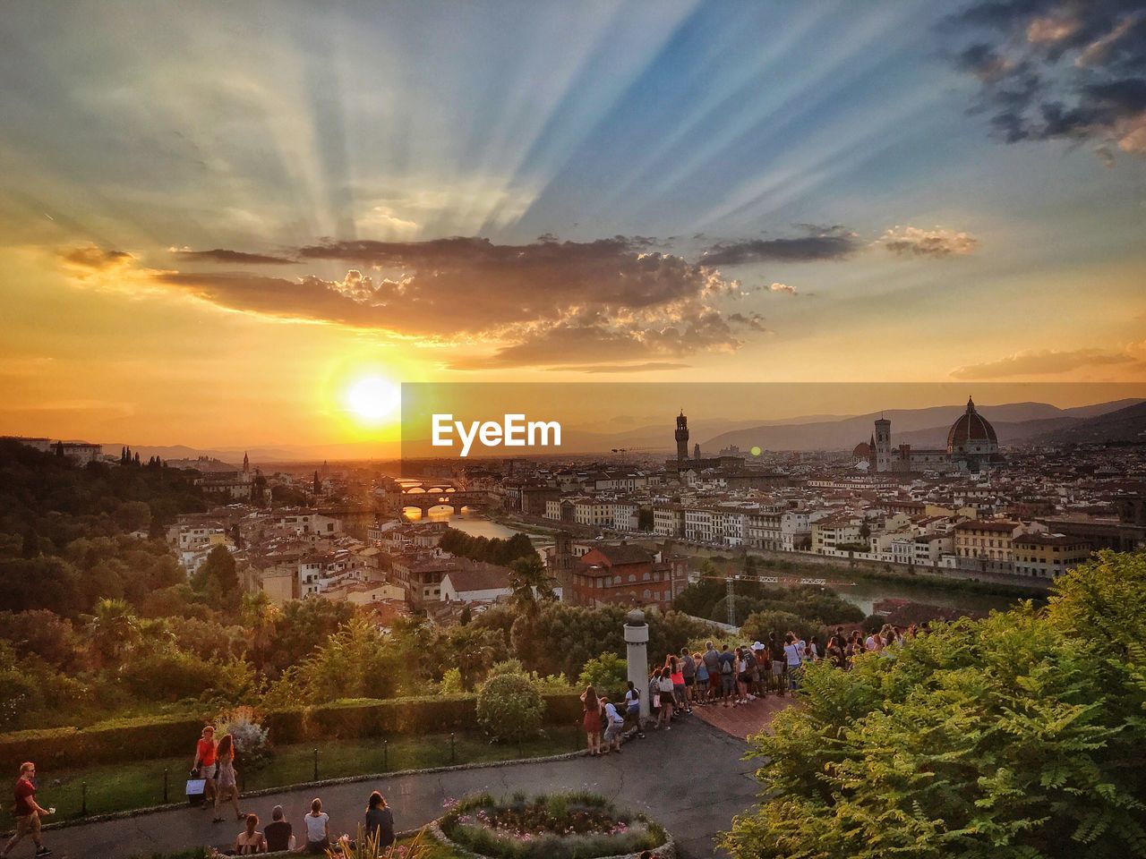 HIGH ANGLE VIEW OF PEOPLE ON CITY DURING SUNSET