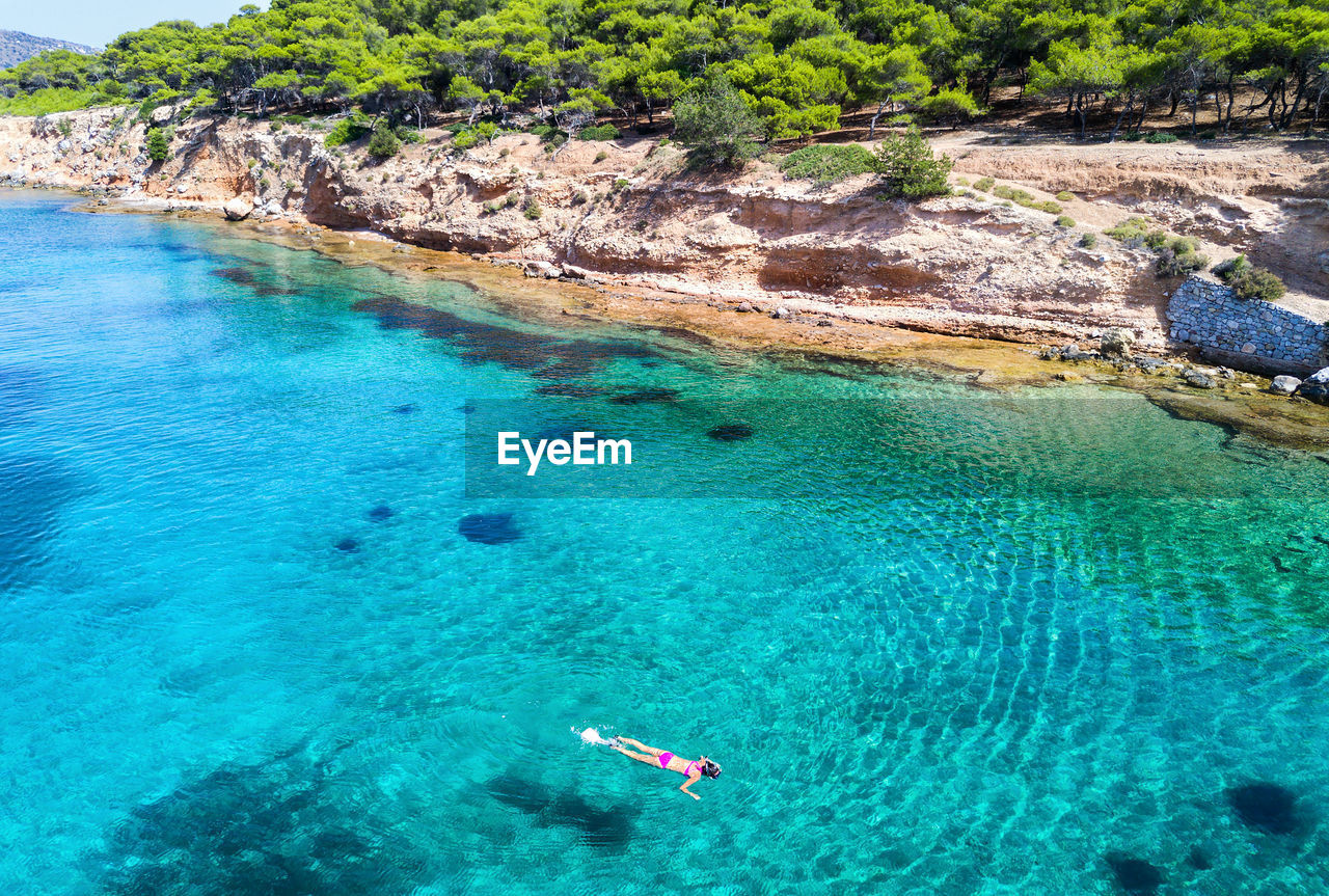 High angle view of woman snorkeling in sea on sunny day