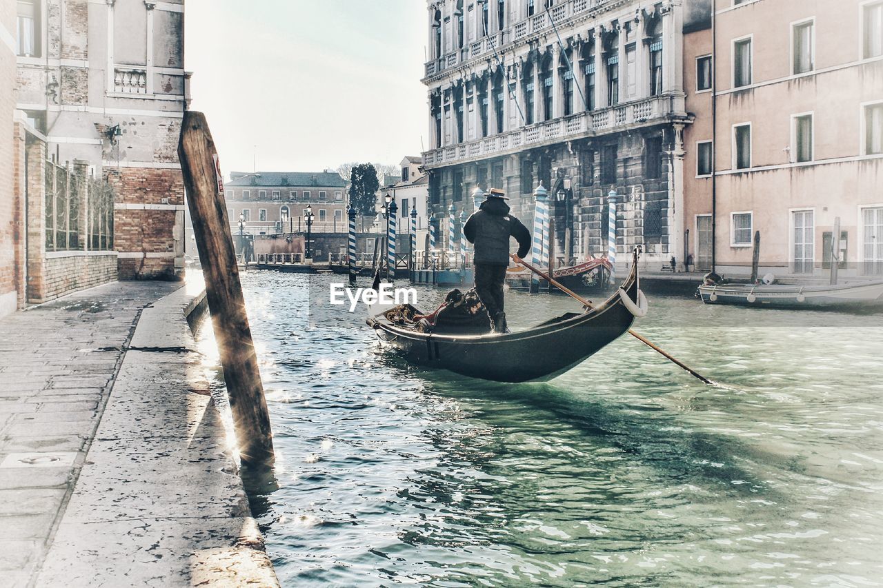 Man on canal in city