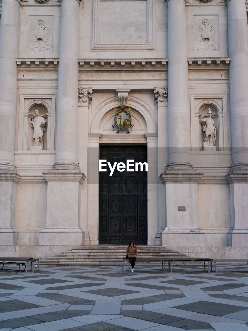 LOW ANGLE VIEW OF WOMAN OUTSIDE BUILDING