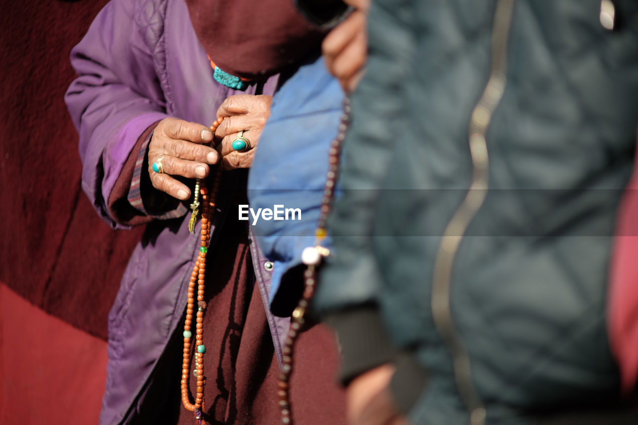 Close-up of hands with prayer beads