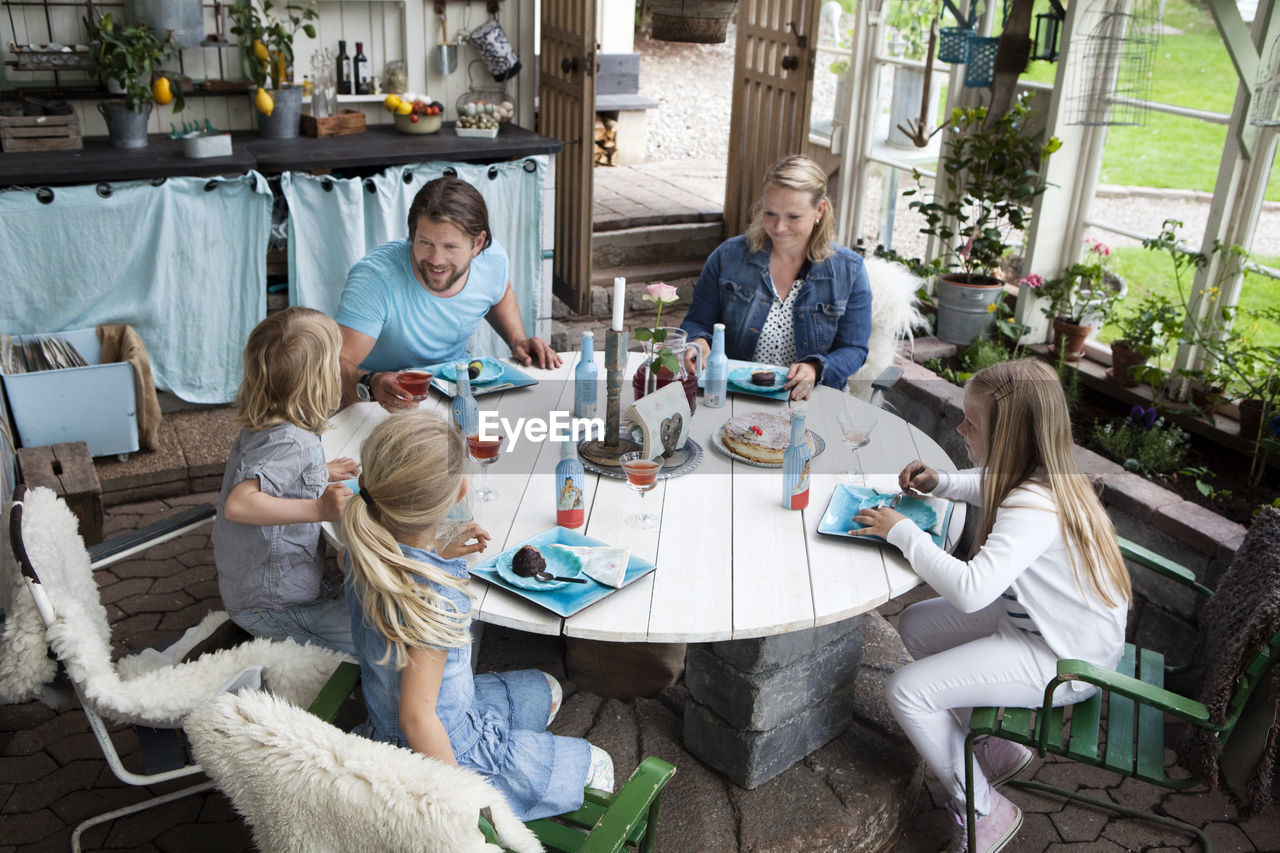 Family with three children eating dessert