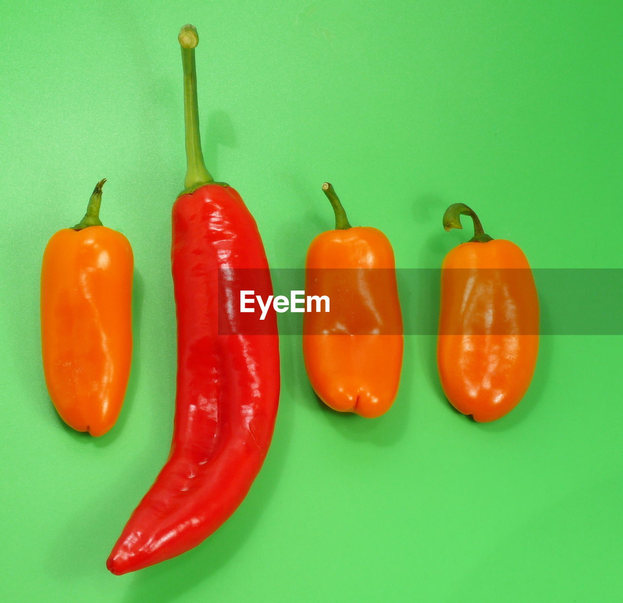 Close-up of chili peppers on green background