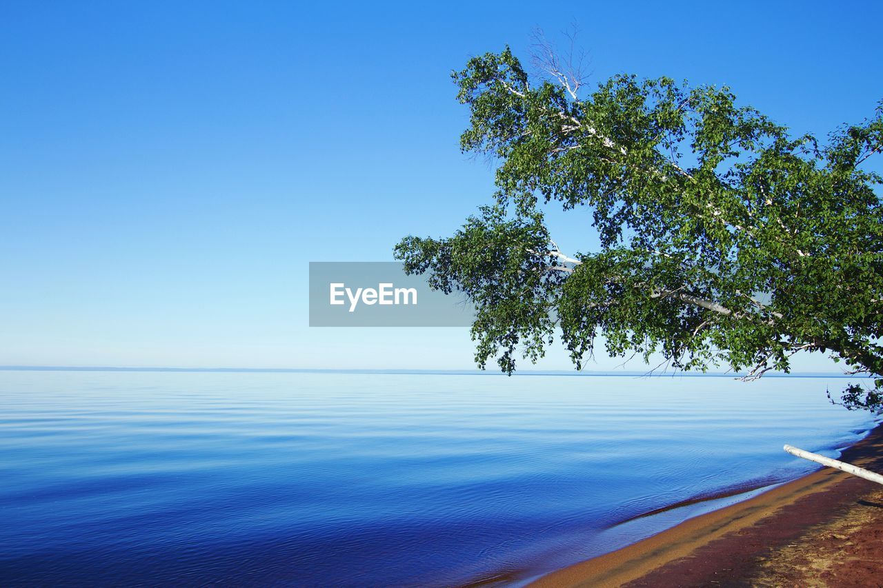 Scenic view of lac saint-jean against blue sky