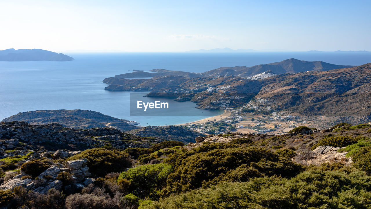 Scenic view of sea and mountains against sky