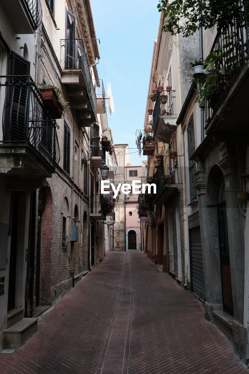 Narrow alley amidst buildings in city