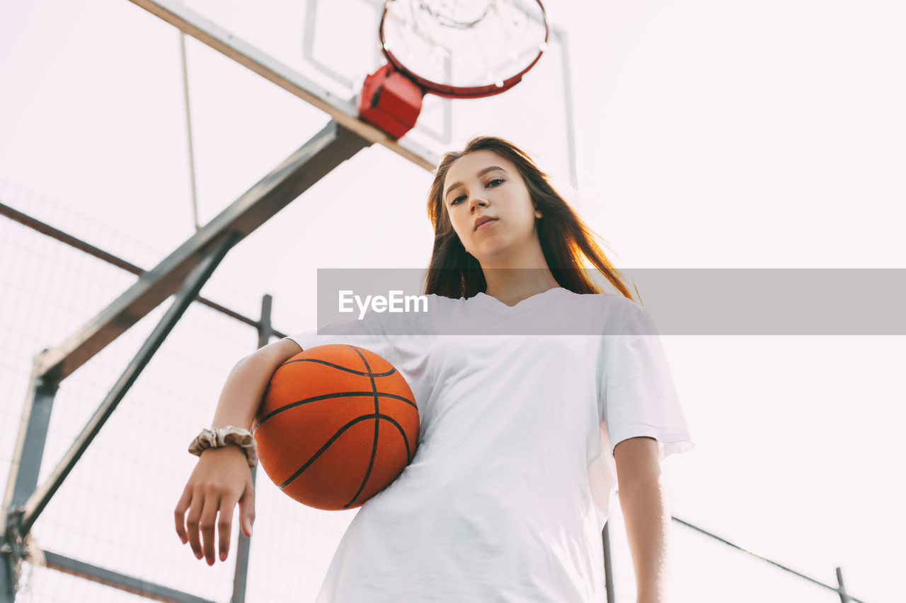 Portrait of young female basketball player. beautiful teen girl playing basketball.