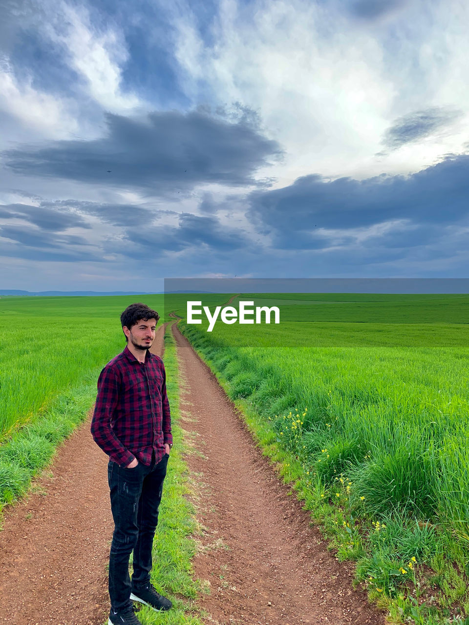 Full length of man standing on field against sky