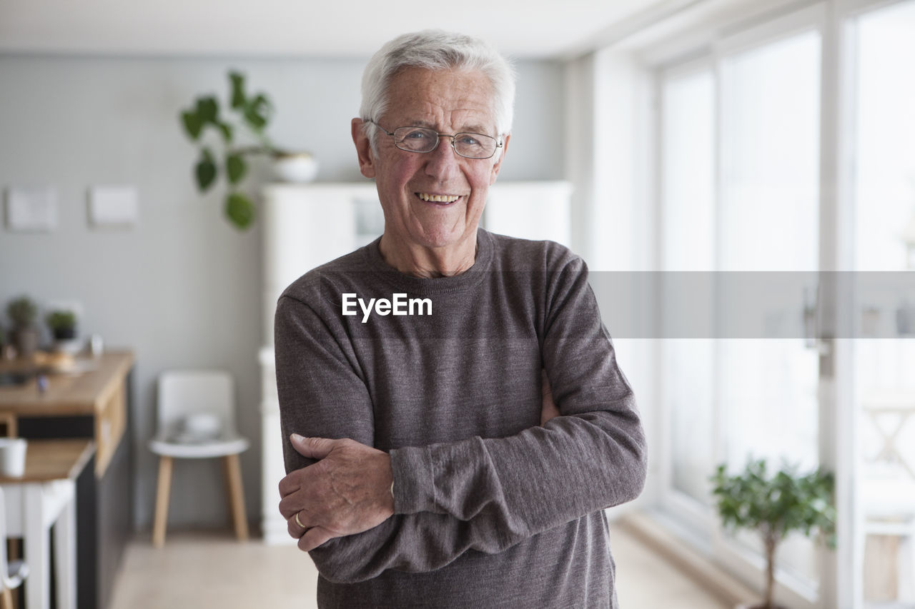 Portrait of smiling senior man at home