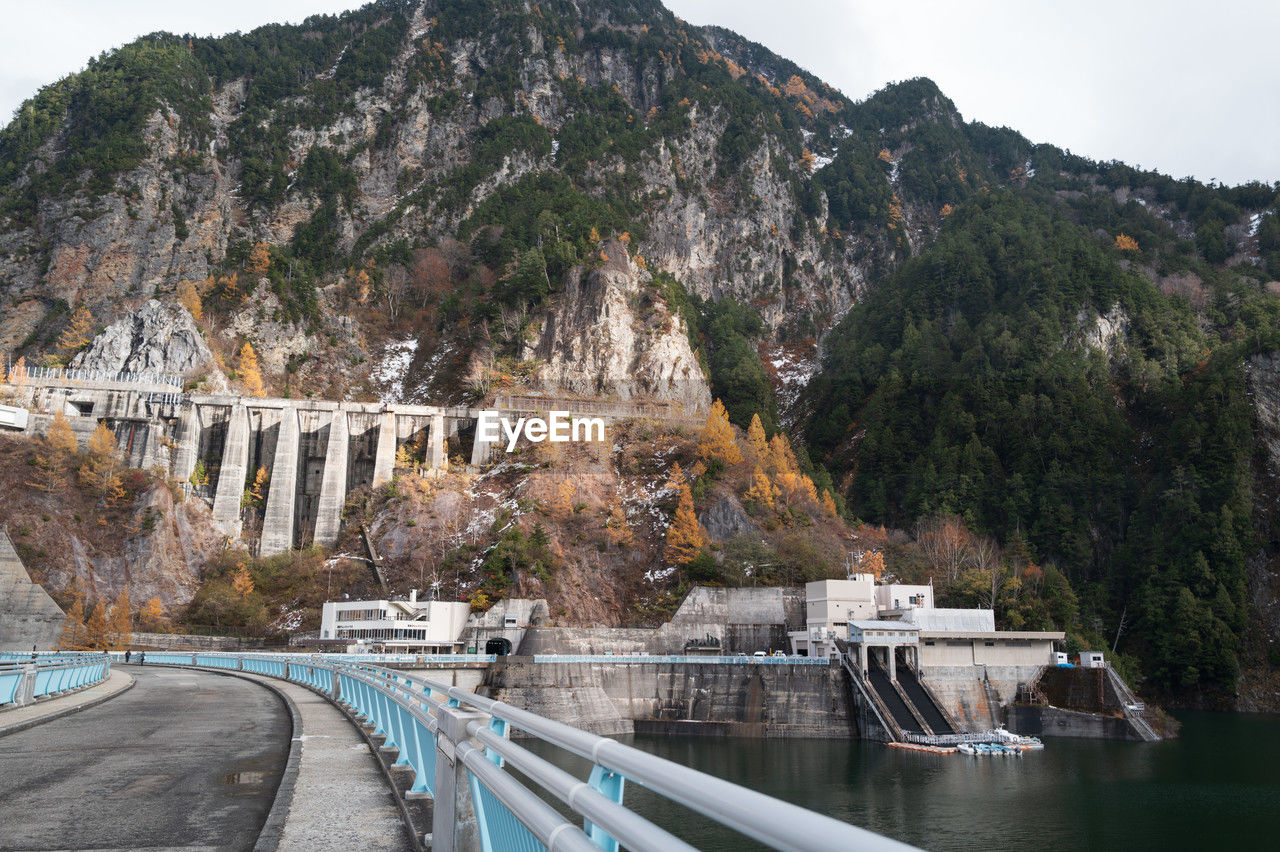 water, architecture, mountain, transportation, built structure, nature, travel destinations, tree, travel, environment, bridge, tourism, sky, plant, scenics - nature, no people, city, land, road, landscape, outdoors, beauty in nature, river, building exterior, day, mode of transportation, vacation, landmark, mountain range, rock