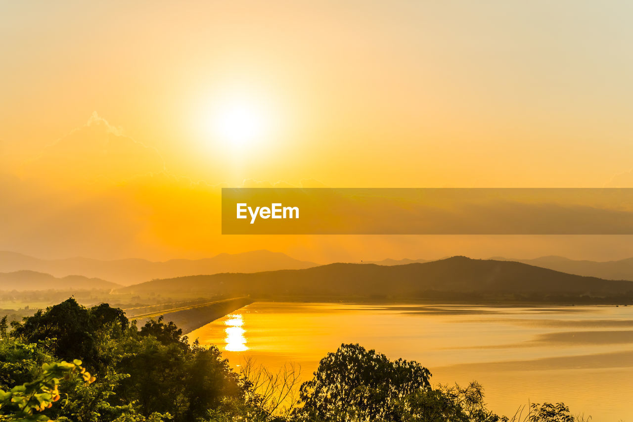 Scenic view of sea against orange sky