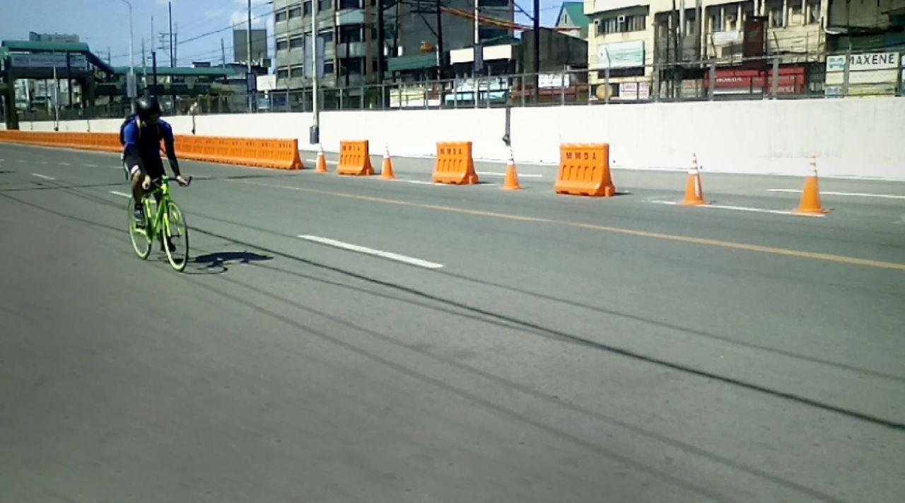 Full length of man cycling on road