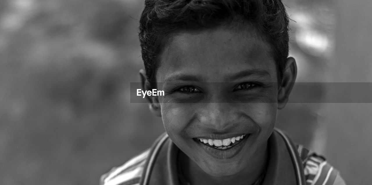 CLOSE-UP PORTRAIT OF CUTE SMILING BOY