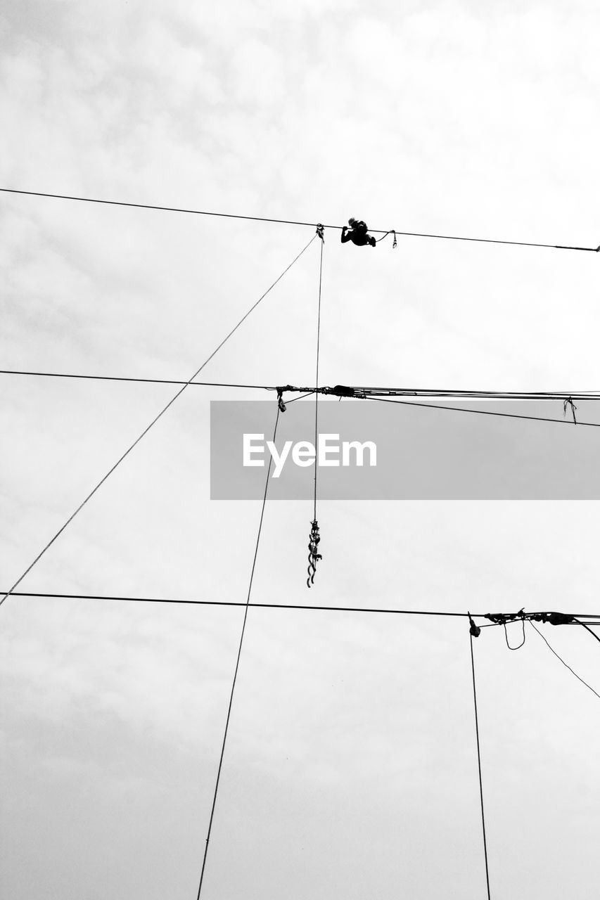 Low angle view of cables against sky