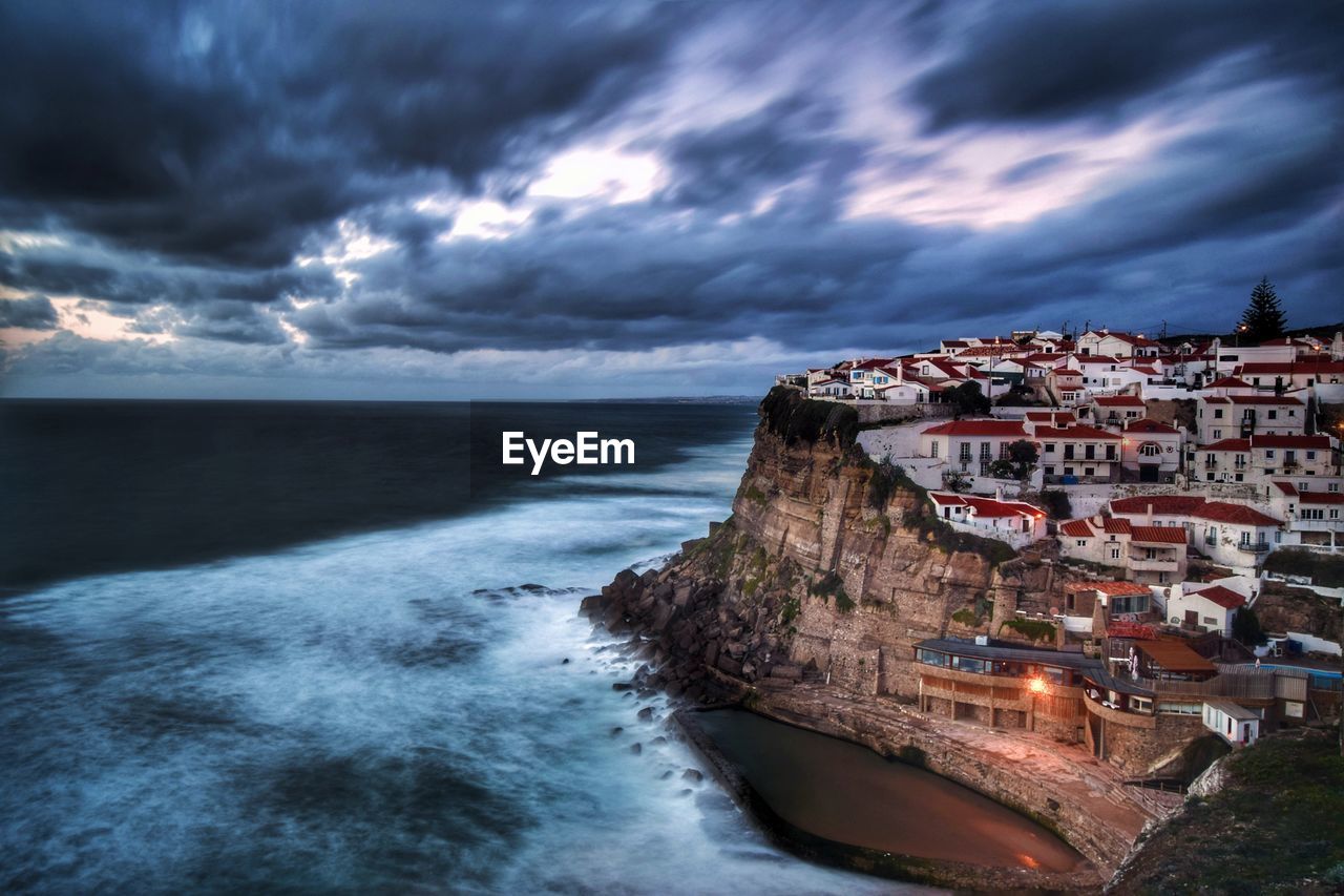 Scenic view of sea against storm clouds