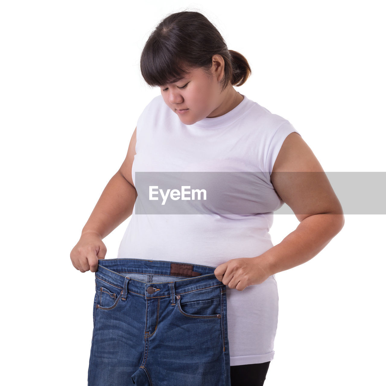 YOUNG WOMAN STANDING ON WHITE BACKGROUND