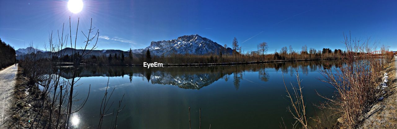 Panoramic view of lake against clear blue sky