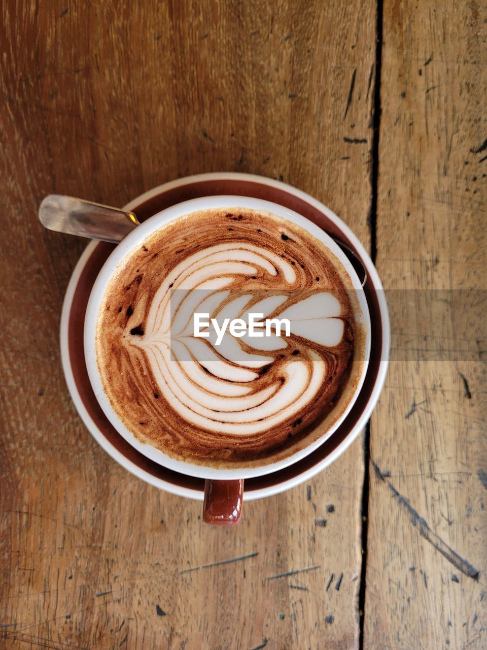 Directly above shot of cappuccino with coffee cup