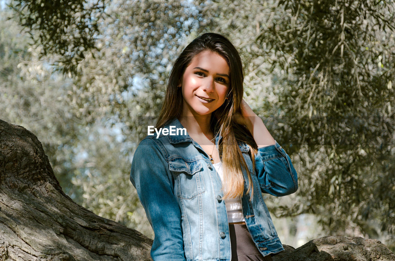 Portrait of smiling young woman standing outdoors